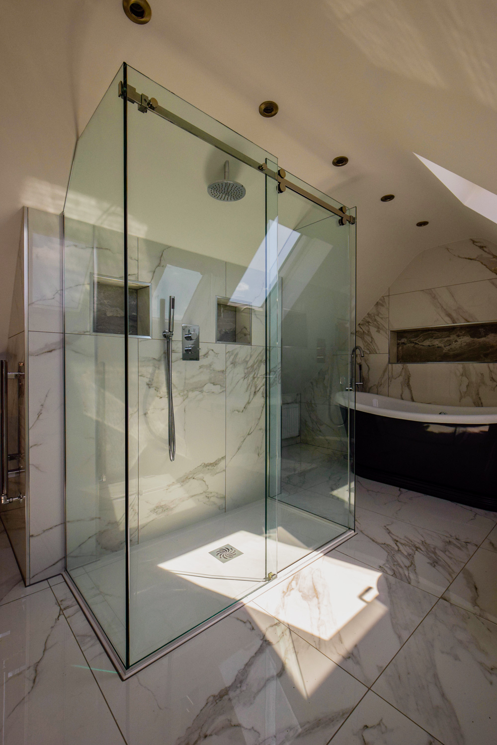 walk-in shower with a curved screen